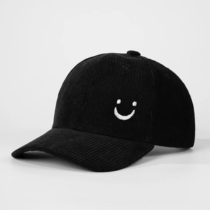 Classic black corduroy baseball cap featuring a white embroidered smiley face design