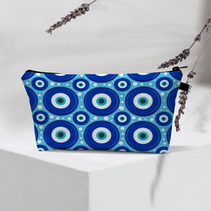 Close-up of waterproof makeup bag featuring blue evil eye patterns and white polka dots
