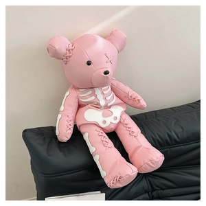 Detail of pink leather bear backpack with white skeleton patches and punk stitching