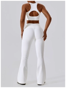 Detail of white ribbed sports bra with hollow back design and flared yoga pants