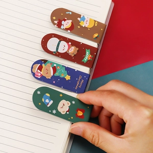 Cute Christmas magnetic bookmarks featuring Santa and snowman patterns on a notebook