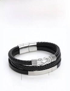 Macro shot of multi-layer woven leather bracelet with polished stainless steel magnetic clasp