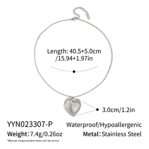 Macro detail of textured silver heart pendant necklace with length and weight specifications