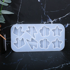 8-cavity silicone resin mold featuring crown, star, and flower shapes on black marble