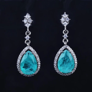 Luxury turquoise teardrop earrings with halo diamonds and silver floral setting