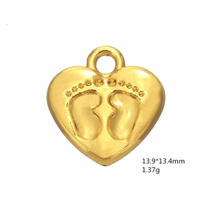 Detailed close-up of golden heart pendant featuring embossed baby footprints and dimensions