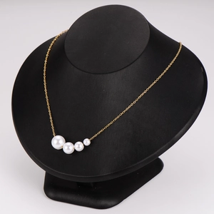 Elegant gold stainless steel necklace featuring five gradient-sized white pearls on model