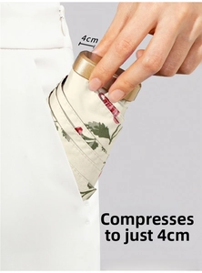 Mini floral umbrella folded to 4cm thickness easily fitting into a pocket