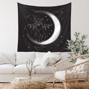 Detail of gothic cat tapestry with bat wings on a crescent moon in a modern living room