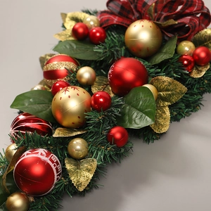 Christmas teardrop swag with red plaid bows and gold ornaments on artificial pine branches