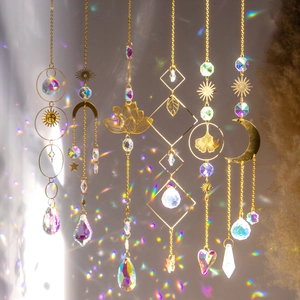 Detailed view of 6 gold metal suncatchers with lotus moon and crystal prisms
