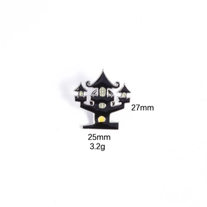 Macro view of haunted house enamel pin showing 27mm height and 25mm width dimensions