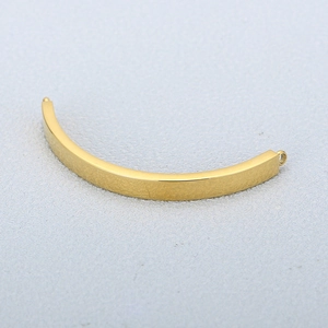 Macro detail of polished gold curved metal bar connector with side ring for DIY jewelry