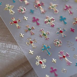 Gilded matte cross nail art stickers in pink, blue, and red with a 3D glitter finish