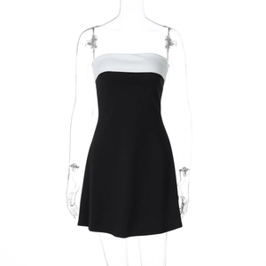 Detailed close-up of a bodycon mini dress with black and white color block design