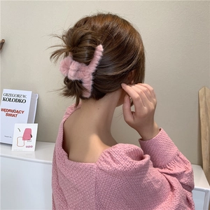 Elegant pink plush hair claw clip for women's thick hair shown on model from behind