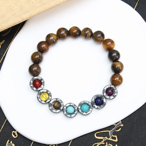 Tiger eye beaded yoga bracelet with seven chakras stones on a white jewelry display