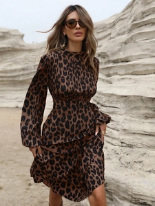 Detail of elegant long-sleeve leopard print maxi dress with satin finish and high neck