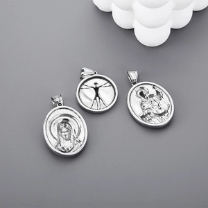 Detailed relief of silver stainless steel pendants with Vitruvian Man and religious icons