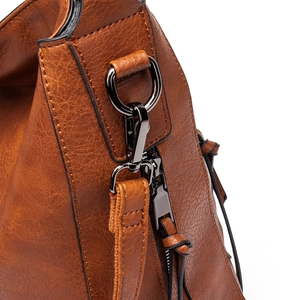Close-up of brown litchi grain leather texture and gunmetal buckle on tote bag