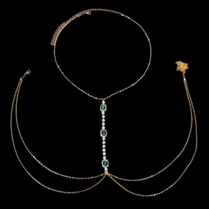 Elegant gold body chain with green rectangle crystals and sparkling diamond tassels