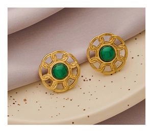 Macro shot of gold vintage round studs with malachite green stone inlay and retro textures