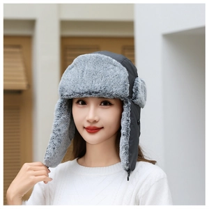 Detailed view of dark grey winter trapper hat with thick faux fur lining for protection