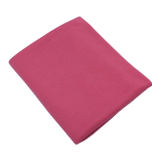 Detailed texture of folded soft pink jersey cotton fabric for stylish autumn scarves