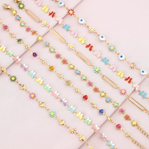 Colorful enamel heart butterfly daisy and evil eye charms on golden stainless steel bracelets