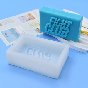 Silicone mold for Fight Club soap and finished blue soap bar with embossed letters