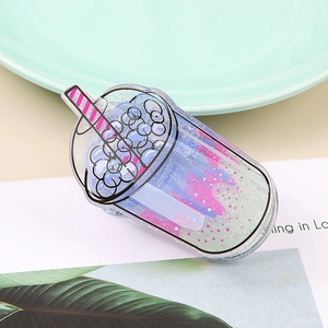 Close-up of a creative acrylic milk tea cup claw clip with colorful moving liquid and glitter