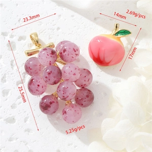 Detailed view of grape and peach resin pendants with dimensions and weights