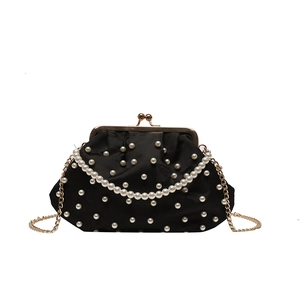 Elegant black satin shell bag with pearl studs, gold chain, and clasp closure