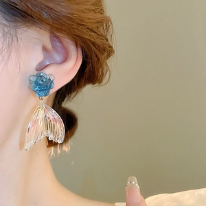 Elegant blue acrylic flower and iridescent fishtail drop earrings on model