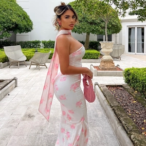 Detail of elegant slim fit floral maxi dress with backless design and stylish neck ribbon