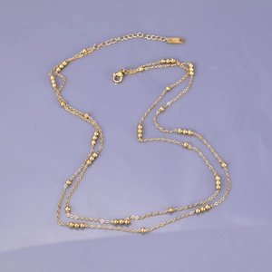 Double-layered gold beaded necklace in stainless steel with adjustable lobster clasp