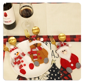 Detailed view of Christmas cutlery holders featuring Santa, elk, and snowman designs
