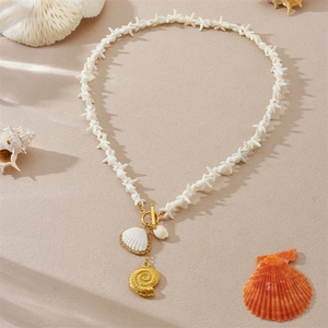 Retro seaside necklace featuring white starfish, golden shells, and conch on sand