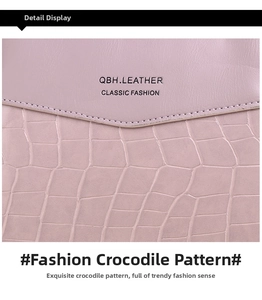 Detail view of pinkish-purple crossbody bag with smooth leather and crocodile texture