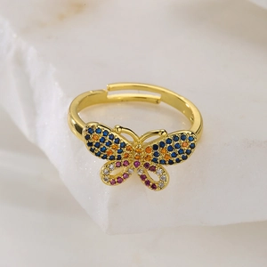 Detail of 18K gold butterfly open ring with colorful zircon stones on stone base