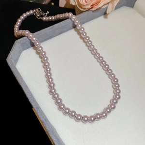 Close-up of elegant lavender pearl necklace displayed in a luxury jewelry gift box