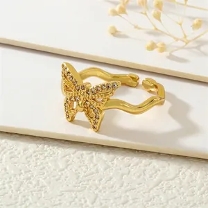 Detailed macro view of 18K gold butterfly ring featuring sparkling zircon inlay accents