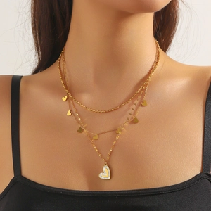 Three-layer gold stainless steel necklace featuring small hearts and a shell heart pendant
