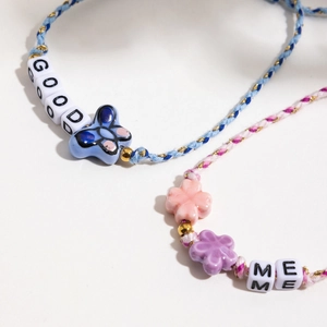 Colorful woven bracelet set with ceramic flowers, butterfly charms and letter beads