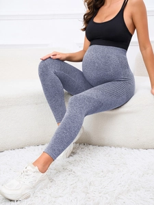 Detail of high-waist maternity yoga leggings in heather gray showing seamless knit texture