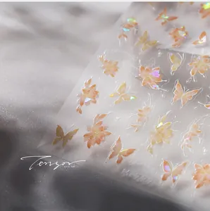 Macro detail of M-727 holographic butterfly and flower gold stamping nail art stickers