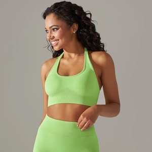 Detail view of the ribbed hem and seamless knit texture of the neon green halter bra