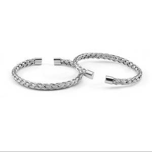 Detail of silver mesh woven stainless steel cuff bracelets with polished metal end caps