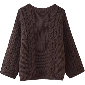Detailed view of dark brown chunky cable knit texture on a crew neck sweater
