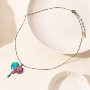 Macro shot of iridescent rainbow heart pendant with unique hollow rib design on steel chain